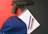 Graduation Turns Deadly — Families Run For Their Lives Handgun beside school supplies and a blue backpack