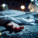 Family Massacre Shocks Iowa Town Crime scene with covered body and hand exposed.