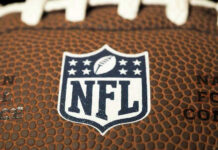 NFL Speed Demon Stunned By Cruel Diagnosis Close-up of NFL logo on American football.