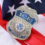 Outsider Tapped To Run ICE ICE officer badge resting on an American flag
