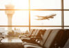 Airline Backlash Explodes Over THIS Rule? View of an airport terminal with an airplane taking off in the background