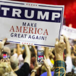 MAGA Slush Fund Implodes Overnight People holding Trump Make America Great Again signs.