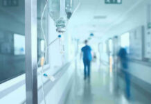 VIDEO: Manhunt Ends After Hospital Murder Hospital corridor with IV drip and healthcare worker.