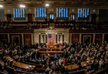 Armed Visits Push Justices Into Congress A crowded congressional chamber with members gathered around the central podium