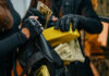 Individuals in black clothing stealing money and items