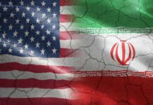 American Blood Spills — What Did Iran Hit? Flags of the United States and Iran blended together with a cracked texture