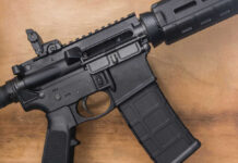 AR-15 Bans Head To The Supreme Court Black rifle on wooden surface close up