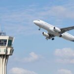 Airport Gate Arrests Spike — What Changed? An airplane taking off near an airport control tower