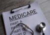 Medicare Shock Looms After 2026? Clipboard with handwritten text about Medicare supplement insurance next to a stethoscope
