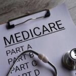 Clipboard with handwritten text about Medicare supplement insurance next to a stethoscope