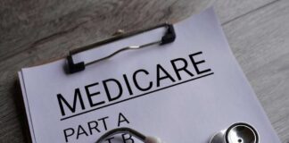 Clipboard with handwritten text about Medicare supplement insurance next to a stethoscope
