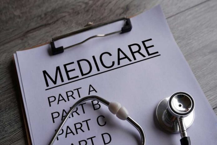 Clipboard with handwritten text about Medicare supplement insurance next to a stethoscope