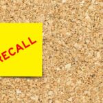 RECALL: Back Seat Time Bomb? Yellow sticky note with the word 'RECALL' on a corkboard