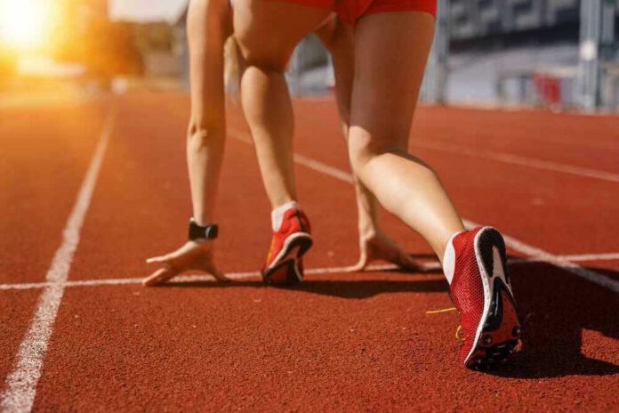 shutterstock_2495703167 Athlete on starting line of a track.