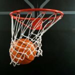 Basketball swishing through a hoop