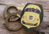ICE Grab Triggers Virginia Murder Uproar ICE officer badge next to handcuffs on a wooden surface