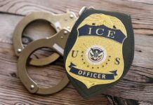 ICE Grab Triggers Virginia Murder Uproar ICE officer badge next to handcuffs on a wooden surface