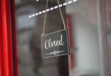 Pizza Bloodbath: 50 Stores Vanish A closed sign hanging on a shop window