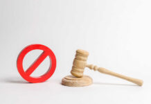 Maxwell’s ‘Rigged Trial’ Claim OBLITERATED Wooden judge's gavel beside a red prohibition symbol