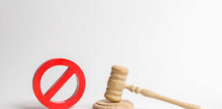 Wooden judge's gavel beside a red prohibition symbol