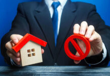 Rich Buyers Feast, Starter Dreams Stall Businessman holding house model and prohibition sign