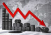 America’s Oil Backstop Thin — Next Shock Looms? Graph depicting a decline in oil prices with barrels in the foreground