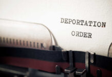 Deportation Deal Sparks Chaos? Close-up of a typewriter with a paper showing the words 'DEPORTATION ORDER'