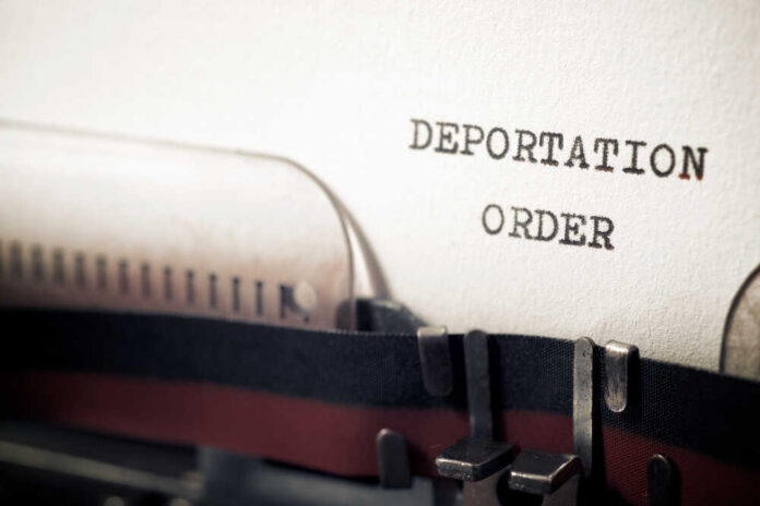 Deportation,Order,Phrase,Written,With,A,Typewriter. Close-up of a typewriter with a paper showing the words 'DEPORTATION ORDER'