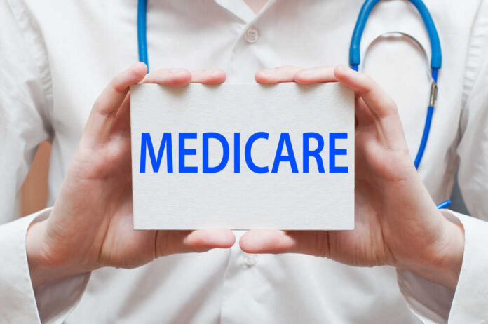 Medicare,-,Medical,Doctor,Shows,Information A medical professional holding a sign that says MEDICARE