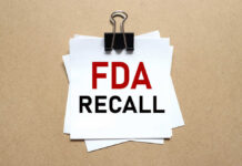 Glass In Frozen Treat? Check Your Freezer NOW! A notice labeled 'FDA RECALL' clipped to white papers on a brown background