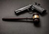 Texas Judge Guts 90-Year Gun Law Pistol and judge's gavel on dark surface