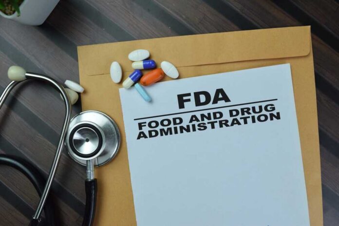 Concept,Of,Fda,-,Food,And,Drug,Administration,Write,On FDA document with pills and a stethoscope on a wooden surface