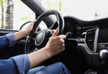 Seat Belt Flaw Triggers Big Recall Hands gripping a steering wheel inside a car