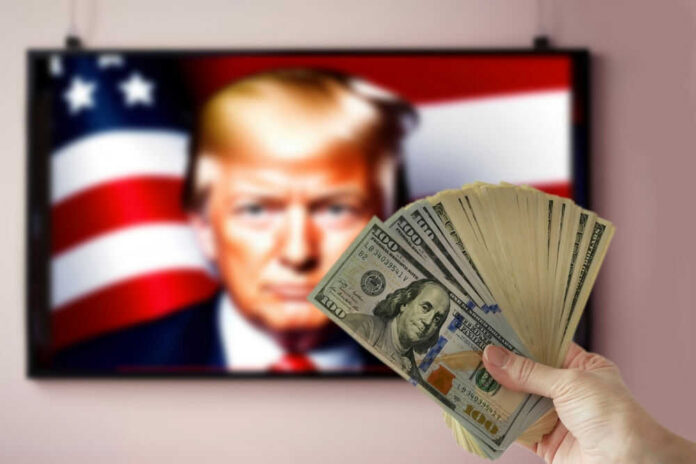shutterstock_2518625675 Hand holding cash in front of American flag background with Donald Trumps face