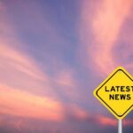 TikTok Star’s Final Post Stuns Millions Yellow diamond sign reading latest news against a colorful sunset sky
