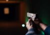 Armed Lurker Shadows Trump Golf Plans Hands aiming a pistol at an indoor shooting range
