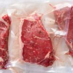 Beef Crunch Slams Consumers — Plants Axed Three vacuum sealed steaks on a white surface
