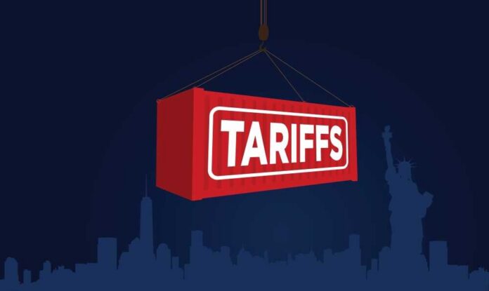 shutterstock_2607253429 Red shipping container labeled 'TARIFFS' suspended above a city skyline
