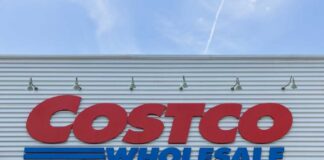 Costco Wholesale store sign against a blue sky