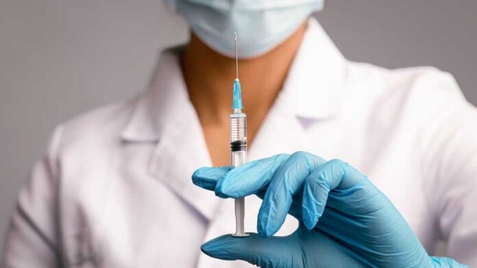 Vaccination,Concept.,Unrecognizable,Female,Doctor,Clutching,Syringe,With,Coronavirus,Covid-19 vaccine