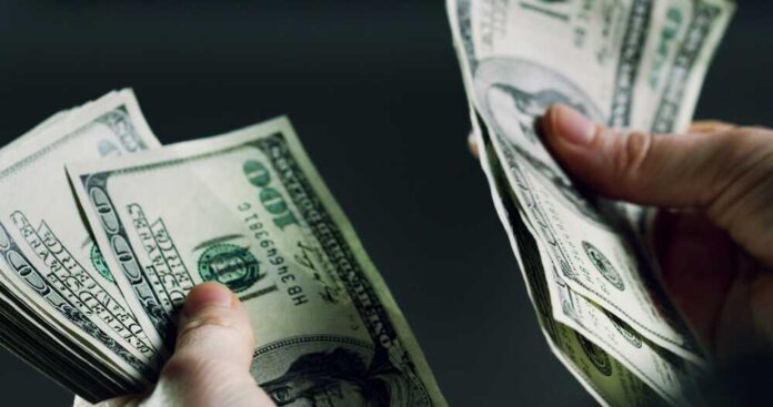 Hands,,Person,And,Counting,Cash,For,Fraud,Crime,,Money,Laundering Hands holding and counting stacks of cash