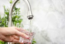 Water Shutoffs Hit San Juan — 48 Hours Dry Hand filling pitcher with water from faucet.