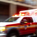 Lightning Blast Injures 16 Inmates Ambulance with flashing lights speeding through a city street