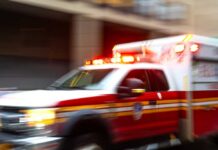 Lightning Blast Injures 16 Inmates Ambulance with flashing lights speeding through a city street
