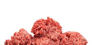 Two raw ground meat patties on a dark surface