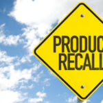 Food Inspection Dodge Sparks Massive Recall Yellow product recall sign against cloudy sky
