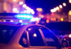 In-N-Out Bloodbath Sparks More Questions Police car with flashing blue lights at night.