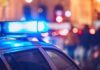 VIDEO: Pre-Dawn Carnage Leaves 23 Dead Close-up of a police car with blue emergency lights in a city at night
