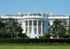 White House Ban EXPLODES – Court Showdown Next The White House, front view with fountain and flag.
