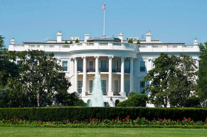 shutterstock_123008023 The White House, front view with fountain and flag.